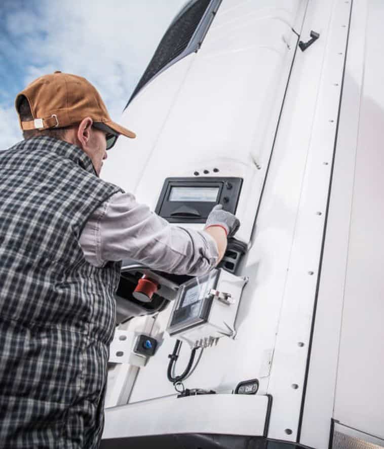 Truck Driver Adjusting Temperature in Refrigerated Truck